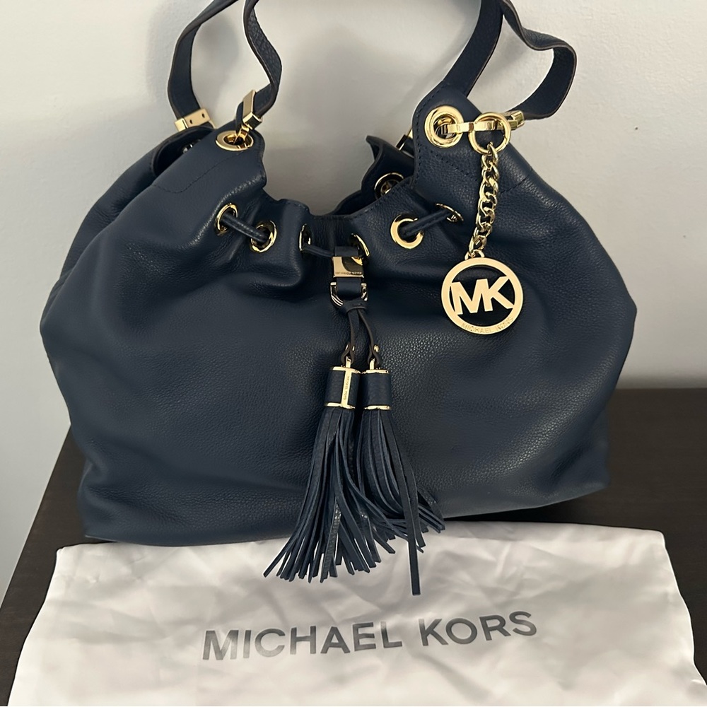 Michael Kors blue leather handbag with gold accents.